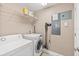 Laundry room including washer, dryer, shelving, and cleaning supplies at 3737 S Atlantic Ave # 502, Daytona Beach, FL 32118