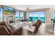 Bright living room with ocean views, comfortable seating, and a cozy fireplace at 3737 S Atlantic Ave # 502, Daytona Beach, FL 32118
