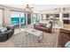 Bright living room featuring a leather sofa, tile floors, and a sliding glass door leading to a balcony overlooking the ocean at 3737 S Atlantic Ave # 502, Daytona Beach, FL 32118