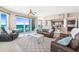 Cozy living room featuring a leather sofa, patterned rug, and balcony access with stunning views of the ocean at 3737 S Atlantic Ave # 502, Daytona Beach, FL 32118