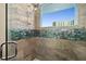 Walk-in shower with glass enclosure and tile accents at 3737 S Atlantic Ave # 502, Daytona Beach, FL 32118