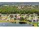 Aerial view of home with mature trees, lake frontage, and lush landscaping in a quiet neighborhood at 39 Ormond Green Blvd, Ormond Beach, FL 32174