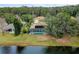 Aerial view of home with screened pool overlooking a lake at 39 Ormond Green Blvd, Ormond Beach, FL 32174