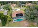 Aerial view of home with pool, spa, screened in lanai and solar panels at 39 Ormond Green Blvd, Ormond Beach, FL 32174