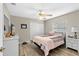 Bedroom with wood-look floors, ceiling fan, and closet at 39 Ormond Green Blvd, Ormond Beach, FL 32174