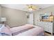 Bedroom with wood-look floors, ceiling fan, and television at 39 Ormond Green Blvd, Ormond Beach, FL 32174