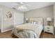 Cozy bedroom featuring a ceiling fan and a mirror hanging on the wall at 39 Ormond Green Blvd, Ormond Beach, FL 32174