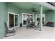 Covered patio with outdoor seating, ceiling fan, and access to the interior, blending indoor and outdoor living at 39 Ormond Green Blvd, Ormond Beach, FL 32174