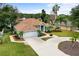 Inviting single-story home with lush front yard landscaping and a two-car garage, showcasing curb appeal at 39 Ormond Green Blvd, Ormond Beach, FL 32174