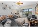 Open-concept living room featuring modern decor, wood floors, and sliders to outdoor living at 39 Ormond Green Blvd, Ormond Beach, FL 32174