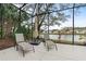 Enclosed patio overlooking the lake is furnished with lounge chairs and an umbrella for relaxing outdoors at 39 Ormond Green Blvd, Ormond Beach, FL 32174