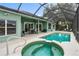 Inviting pool area with a spa, shaded patio, and ample seating for relaxation and entertainment at 39 Ormond Green Blvd, Ormond Beach, FL 32174