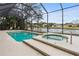 Beautiful pool and spa with scenic water views, patio seating, and a screened enclosure for outdoor enjoyment at 39 Ormond Green Blvd, Ormond Beach, FL 32174