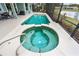 Relaxing pool and spa with inviting clear water surrounded by patio, trees, and a serene water view at 39 Ormond Green Blvd, Ormond Beach, FL 32174