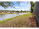 Scenic water view featuring a tranquil lake with a fountain, complemented by green grass and foliage at 39 Ormond Green Blvd, Ormond Beach, FL 32174