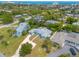 Aerial view showcasing a house with a large yard, driveway and ocean view at 469 S Halifax Dr, Ormond Beach, FL 32176
