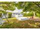 Large backyard with tree coverage and patio at 469 S Halifax Dr, Ormond Beach, FL 32176