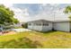 Backyard with firepit, patio, and detached shed at 469 S Halifax Dr, Ormond Beach, FL 32176