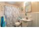 Simple bathroom with a shower/tub combo, white vanity, and tiled flooring at 469 S Halifax Dr, Ormond Beach, FL 32176