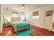 Bedroom with hardwood floors, queen bed, and coastal decor at 469 S Halifax Dr, Ormond Beach, FL 32176