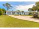 Ranch-style home with a large driveway and nicely landscaped lawn at 469 S Halifax Dr, Ormond Beach, FL 32176