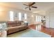 Hardwood floor living room with sectional sofa and ceiling fan at 469 S Halifax Dr, Ormond Beach, FL 32176