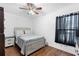 Cozy bedroom with a queen bed, nightstand and ceiling fan at 501 W Lisbon Pkwy, Deland, FL 32720