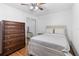 Well-lit bedroom with a queen bed, dresser and ceiling fan at 501 W Lisbon Pkwy, Deland, FL 32720