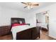 Bedroom with a dark brown bed frame, mirrored closet doors and ceiling fan at 501 W Lisbon Pkwy, Deland, FL 32720