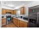 Kitchen with wood cabinets and stainless steel appliances at 501 W Lisbon Pkwy, Deland, FL 32720