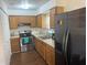 Functional kitchen featuring stainless steel appliances and wooden cabinetry at 501 W Lisbon Pkwy, Deland, FL 32720