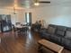Open-concept living room with hardwood floors, ceiling fan, and dining area at 501 W Lisbon Pkwy, Deland, FL 32720