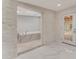 Elegant bathroom with marble accents, a soaking tub, and modern fixtures at 681 N Halifax Dr, Ormond Beach, FL 32176