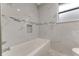 Bathroom with sleek white tile, accent trim, and a large bathtub at 681 N Halifax Dr, Ormond Beach, FL 32176