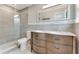 Bathroom with a double vanity, walk-in shower with glass door, and updated fixtures at 681 N Halifax Dr, Ormond Beach, FL 32176