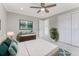 Well-lit bedroom with a ceiling fan, closet, and stylish dresser at 681 N Halifax Dr, Ormond Beach, FL 32176