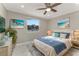Cozy bedroom featuring a queen bed with stylish decor, complemented by a ceiling fan at 681 N Halifax Dr, Ormond Beach, FL 32176
