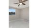 A bright bedroom with a ceiling fan and a window offering an exterior view at 681 N Halifax Dr, Ormond Beach, FL 32176