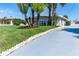Charming single story home with beautiful landscaping, rock border and blue painted drive at 681 N Halifax Dr, Ormond Beach, FL 32176