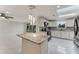 Well-lit kitchen featuring stone countertops, modern appliances, and ample cabinet space at 681 N Halifax Dr, Ormond Beach, FL 32176