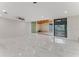 Spacious, open living room with access to an outdoor area, featuring sleek tile floors and modern lighting at 681 N Halifax Dr, Ormond Beach, FL 32176