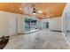 Bright sunroom with travertine tile, skylights, and sliding glass doors leading to a pool area at 681 N Halifax Dr, Ormond Beach, FL 32176