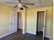 Bright bedroom with wood-look floors and closet at 701 Perkins St # 100, Leesburg, FL 34748