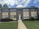 Brick building exterior with landscaping and walkway at 701 Perkins St # 100, Leesburg, FL 34748