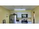 Well-equipped kitchen featuring stainless steel appliances, ample cabinet space, and bright lighting at 701 Perkins St # 100, Leesburg, FL 34748