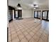 Spacious living area with tile floors and multiple French doors at 8101 Via Bonita St, Sanford, FL 32771