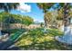 Landscaped backyard with mature trees, putting green, batting cage, and plenty of space to entertain at 878 Abbott Ave, Deltona, FL 32725