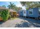 Unique property featuring a mobile home with an orange house and lush landscaping at 878 Abbott Ave, Deltona, FL 32725