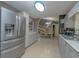 Bright kitchen features stainless steel appliances, a skylight and an open design leading to the dining area at 878 Abbott Ave, Deltona, FL 32725