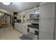 Updated kitchen featuring stainless steel appliances, stylish cabinets, and a mosaic tile backsplash at 878 Abbott Ave, Deltona, FL 32725